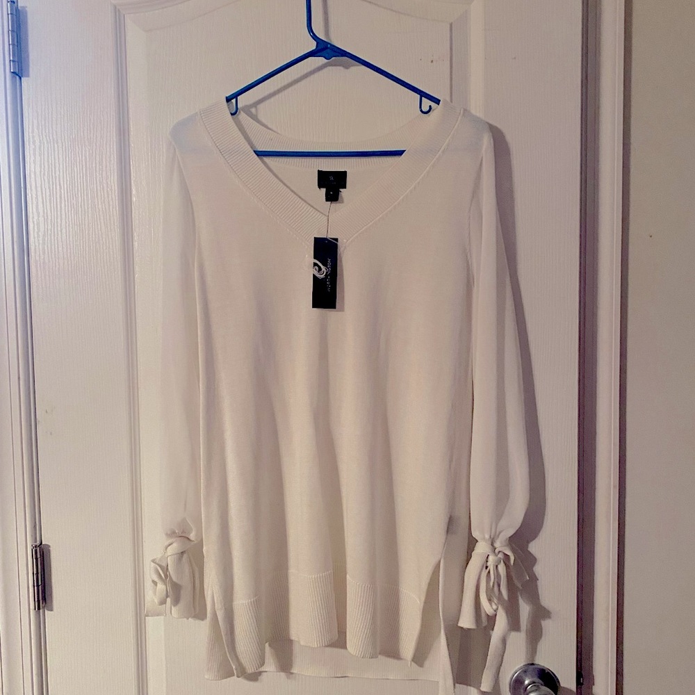 White tunic with sheer sleeves and tie wrist detail.